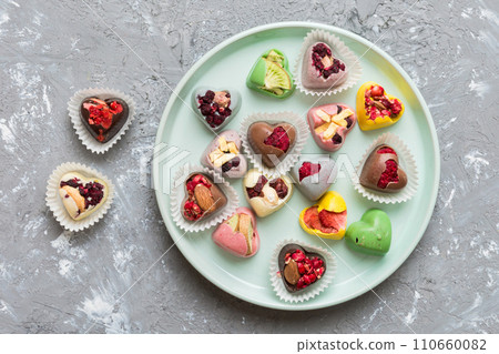 Plate with different chocolate on colored background. Assortment of fine chocolates top view vith copy space Health and obesity concept 110660082
