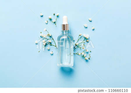 Fancy healthcare bottles for serum, micellar, tonic, toner, lotion, water and cream with gypsophila branch. Natural oranic spa cosmetics concept. Mockup, template, Top view 110660110