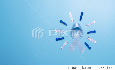 Diabetes awareness concept of ribbon test strips and lancets on blue background with copy-space flat lay. Diabetes awareness concept 110660152