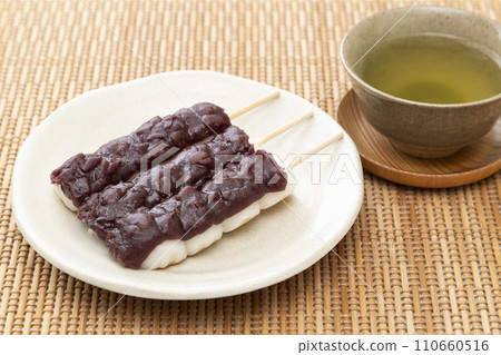 Skewered dumplings and green tea Skewered dumplings and green tea 110660516