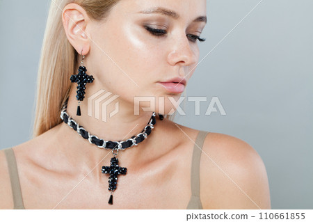 Nice model woman with blonde hair in black jewelry set earrings and choker necklace 110661855