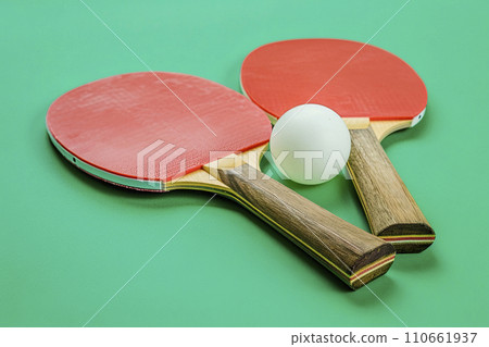 ping pong rackets and ball on green background ping pong rackets and ball on green background 110661937