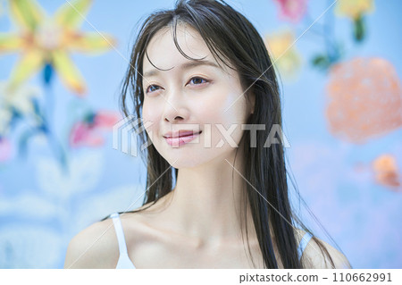 A woman standing in front of brightly patterned wallpaper A woman standing in front of brightly patterned wallpaper 110662991