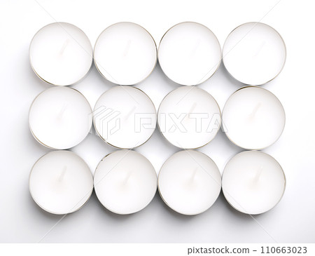 Group of tealights, candles in thin metal cups, so that the wax can liquefy completely while lit. Also known as tea-light, tea light, tea candle, or informally tea lite, t-lite or t-candle. Close-up. Group of tealights, candles in thin metal cups, so that the wax can liquefy completely while lit. Also known as tea-light, tea light, tea candle, or informally tea lite, t-lite or t-candle. Close-up. 110663023