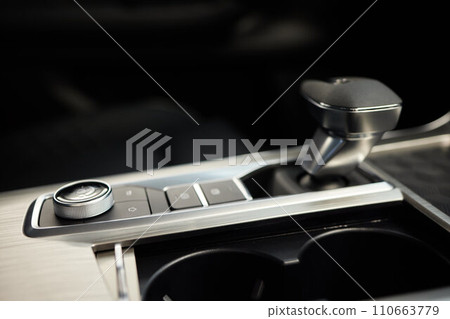Selector automatic transmission with leather in the interior of a modern expensive car. The background is blurred. Black and brown leather car. Selector automatic transmission with leather in the interior of a modern expensive car. The background is blurred. Black and brown leather car. 110663779
