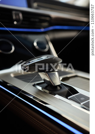 Selector automatic transmission with leather in the interior of a modern expensive car. The background is blurred. Black and brown leather car. Selector automatic transmission with leather in the interior of a modern expensive car. The background is blurred. Black and brown leather car. 110663787