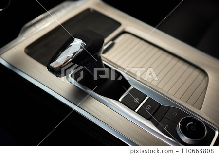 Selector automatic transmission with leather in the interior of a modern expensive car. The background is blurred. Black and brown leather car. 110663808