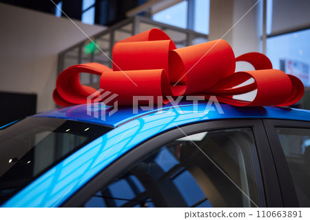 The new car is wrapped in a red bow. Beautiful gift concept. 110663891