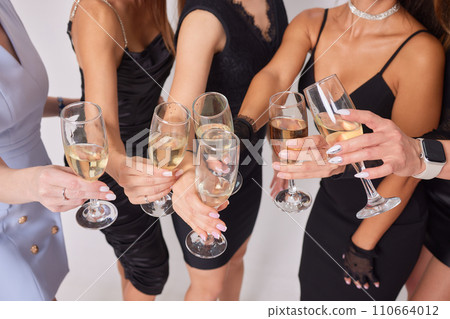 Clinking glasses with alcohol and toasting, party. 110664012