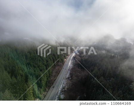 Sea to Sky Highway covered in clouds with Canadian Mountain Landscape. 110664169