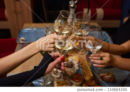Clinking glasses with alcohol and toasting, party. 110664200