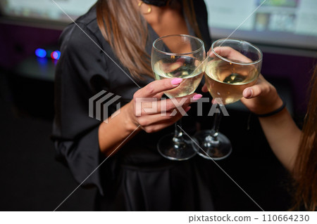 Clinking glasses with alcohol and toasting, party. 110664230