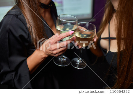 Clinking glasses with alcohol and toasting, party. 110664232