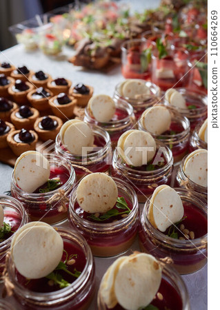 light snacks for the holiday, catering. Various light snacks. Catering plate. Assortment of sandwiches on the buffet table. meat, fish, vegetable canapes. light snacks for the holiday, catering. Various light snacks. Catering plate. Assortment of sandwiches on the buffet table. meat, fish, vegetable canapes. 110664269