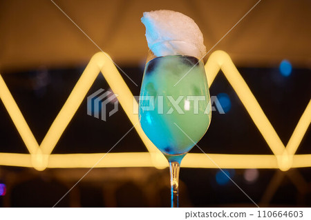 Summer cocktail with fruit and ice. Drink on white table over pink wall in sunlight with palm leaf shadow. Summer, tropical, fresh cocktail concept. Summer cocktail with fruit and ice. Drink on white table over pink wall in sunlight with palm leaf shadow. Summer, tropical, fresh cocktail concept. 110664603