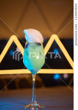 Summer cocktail with fruit and ice. Drink on white table over pink wall in sunlight with palm leaf shadow. Summer, tropical, fresh cocktail concept. Summer cocktail with fruit and ice. Drink on white table over pink wall in sunlight with palm leaf shadow. Summer, tropical, fresh cocktail concept. 110664604