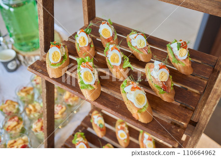 light snacks for the holiday, catering. Various light snacks. Catering plate. Assortment of sandwiches on the buffet table. meat, fish, vegetable canapes. light snacks for the holiday, catering. Various light snacks. Catering plate. Assortment of sandwiches on the buffet table. meat, fish, vegetable canapes. 110664962