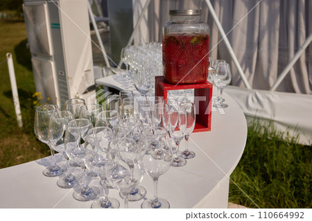 Bowl of delicious aromatic punch drink and glasses on wooden table Bowl of delicious aromatic punch drink and glasses on wooden table 110664992