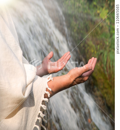 Man praying at the river 110665085