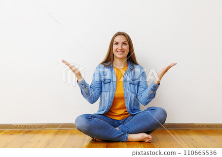 Happy Woman Shrugging in Denim Outfit Indoors 110665536
