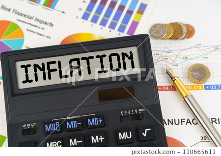 On the table are financial reports, coins and a calculator with the inscription - Inflation On the table are financial reports, coins and a calculator with the inscription - Inflation 110665611