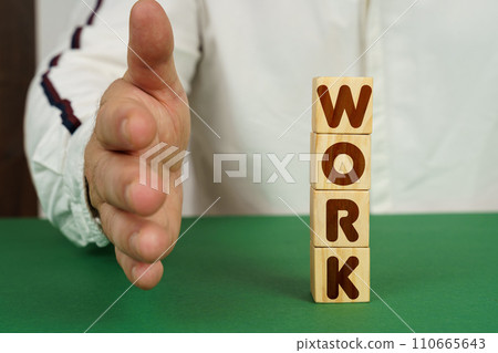 On a green surface, cubes with the inscription - WORK 110665643