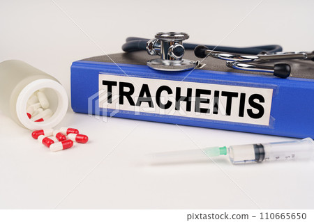 On a white surface there are pills, a syringe and a folder with the inscription - Tracheitis On a white surface there are pills, a syringe and a folder with the inscription - Tracheitis 110665650