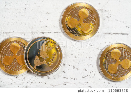 Top down view, golden XRP ripple cryptocurrency coins on white stone board Top down view, golden XRP ripple cryptocurrency coins on white stone board 110665858