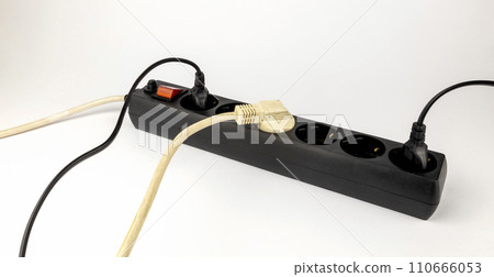 Electric extension cord with 220 V sockets. Extension cord for sockets. The concept of electricity consumption. Electric extension cord with 220 V sockets. Extension cord for sockets. The concept of electricity consumption. 110666053