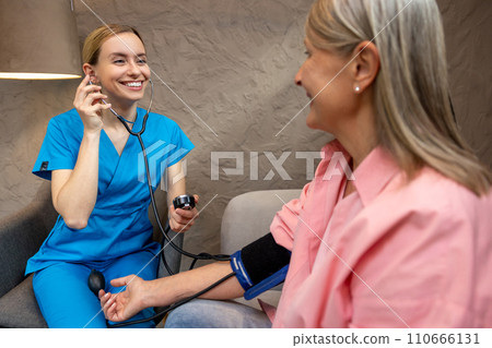 Mature woman controlling blood pressure. 110666131