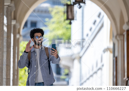 Young man having a video call and looking excited Young man having a video call and looking excited 110666227