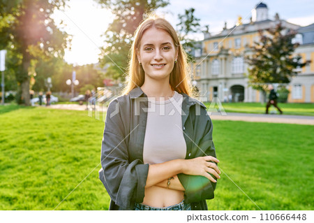 Portrait of young teenage female looking at camera outdoor 110666448