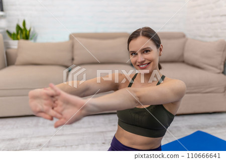 Cute young woman doing yoga at home and looking relaxed 110666641