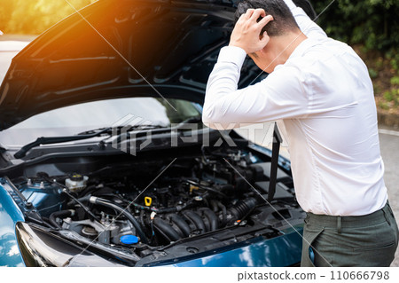Asian businessman car broken breakdown, angry young stressed man stands trouble car failure problem looking in frustration at failed engine in morning, accident on road outdoor, late for business work 110666798