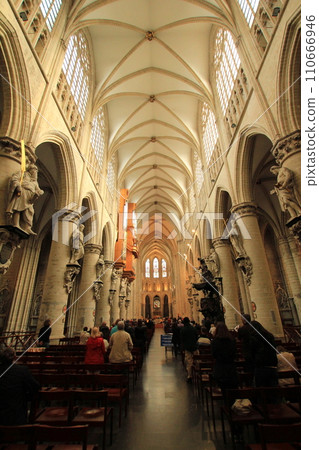 People praying in the nave of Saint-Michel Cathedral (Brussels, Belgium) People praying in the nave of Saint-Michel Cathedral (Brussels, Belgium) 110666946