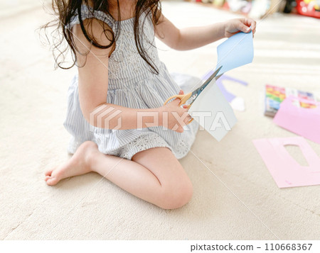 Child cutting origami with scissors Child cutting origami with scissors 110668367