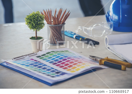 construction engineer office desk architect workplace. engineer drawing objects table with meter, blueprint, hard hat engineering stuff on desk. Designer Objects drafting workplace on wooden table. construction engineer office desk architect workplace. engineer drawing objects table with meter, blueprint, hard hat engineering stuff on desk. Designer Objects drafting workplace on wooden table. 110668917