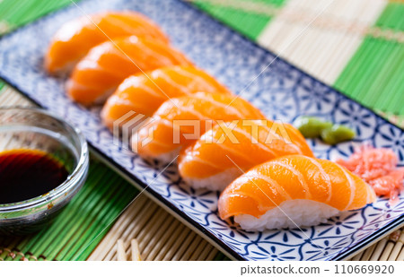 Sushi set of nigiri, served on rectangular plate 110669920
