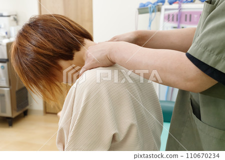 Image of chiropractic and massage treatment with a female patient with neck stiffness and shoulder stiffness Image of chiropractic and massage treatment with a female patient with neck stiffness and shoulder stiffness 110670234