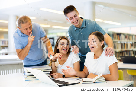 Mature man tells a group of young students to be quiet 110670450
