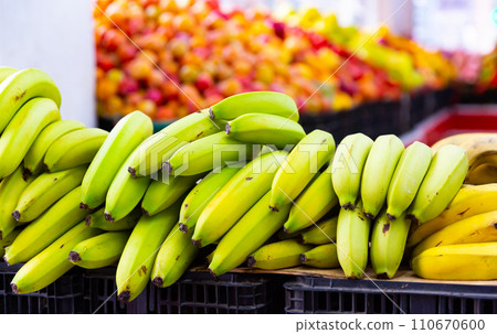 Bunches of yellow bananas on the stand in open-air fruit and vegetable market 110670600