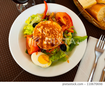 Goat cheese salad with vegetables 110670698