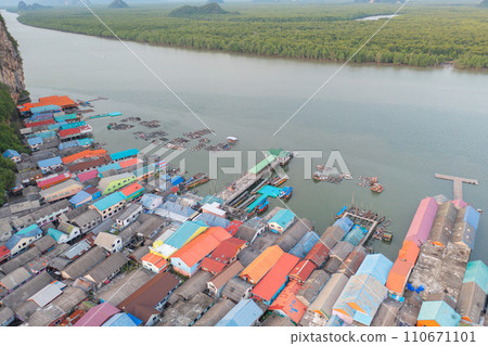 Aerial view of Koh Panyee, The Floating village urban city town houses, lake sea or river. Nature landscape fisheries and fishing tools at Pak Pha, Phang Nga, Thailand. Aquaculture farming Aerial view of Koh Panyee, The Floating village urban city town houses, lake sea or river. Nature landscape fisheries and fishing tools at Pak Pha, Phang Nga, Thailand. Aquaculture farming 110671101