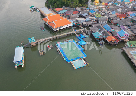 Aerial view of Koh Panyee, The Floating village urban city town houses, lake sea or river. Nature landscape fisheries and fishing tools at Pak Pha, Phang Nga, Thailand. Aquaculture farming 110671126
