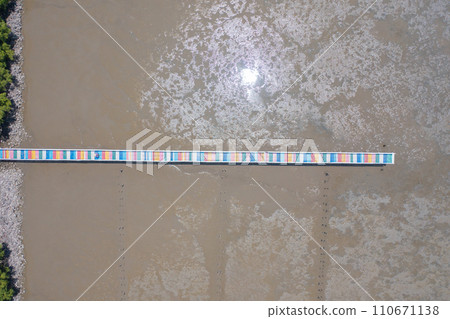 Aerial top view of the rainbow bridge with sea, river, pond or lake. Nature landscape, Samut Sakhon, Thailand. 110671138