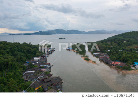 Aerial view of Ranong City, The Floating village urban city town houses, lake sea or river. Nature landscape fisheries and fishing tools, Thailand. Aquaculture farming Aerial view of Ranong City, The Floating village urban city town houses, lake sea or river. Nature landscape fisheries and fishing tools, Thailand. Aquaculture farming 110671145