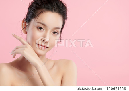 Beautiful young asian woman with clean fresh skin on pink background, Face care, Facial treatment, Cosmetology, beauty and spa, Asian women portrait. Beautiful young asian woman with clean fresh skin on pink background, Face care, Facial treatment, Cosmetology, beauty and spa, Asian women portrait. 110671538