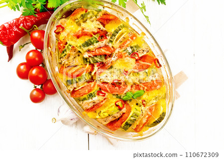 Casserole with chicken and vegetables in brazier on board top 110672309