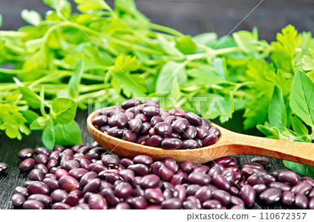 Haricot ruby in a spoon on dark board 110672357