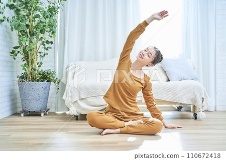 A young woman stretching in the room A young woman stretching in the room 110672418